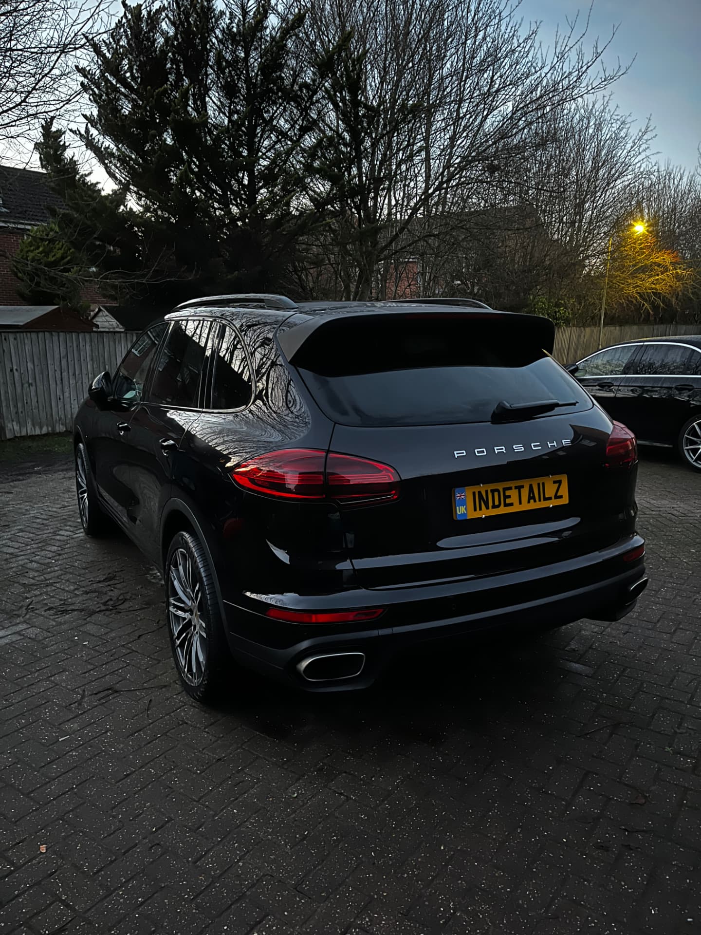 Black Porsche Cayenne with INDETAILZ plate after a detail