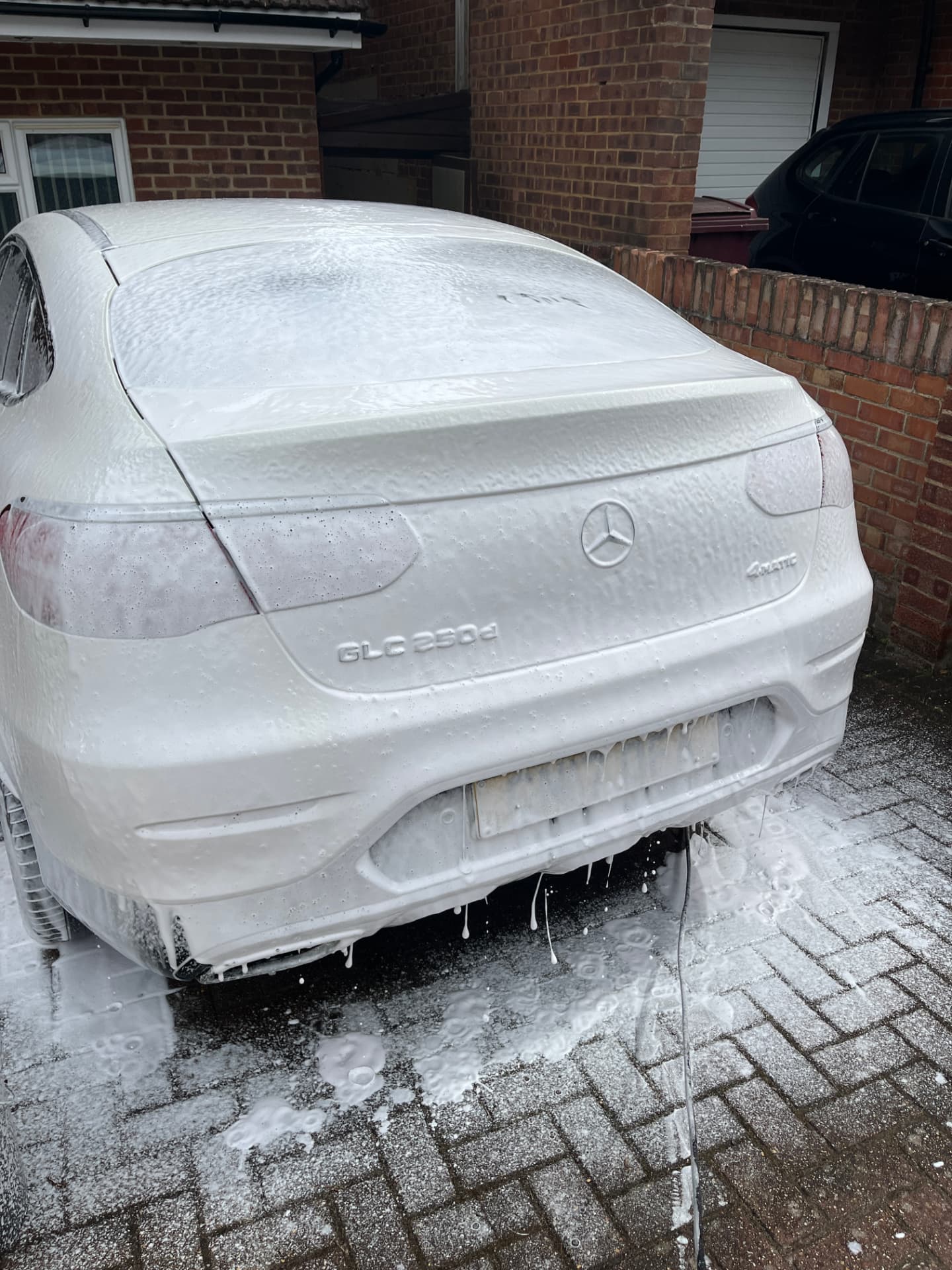 White Mercedes covered in snow foam